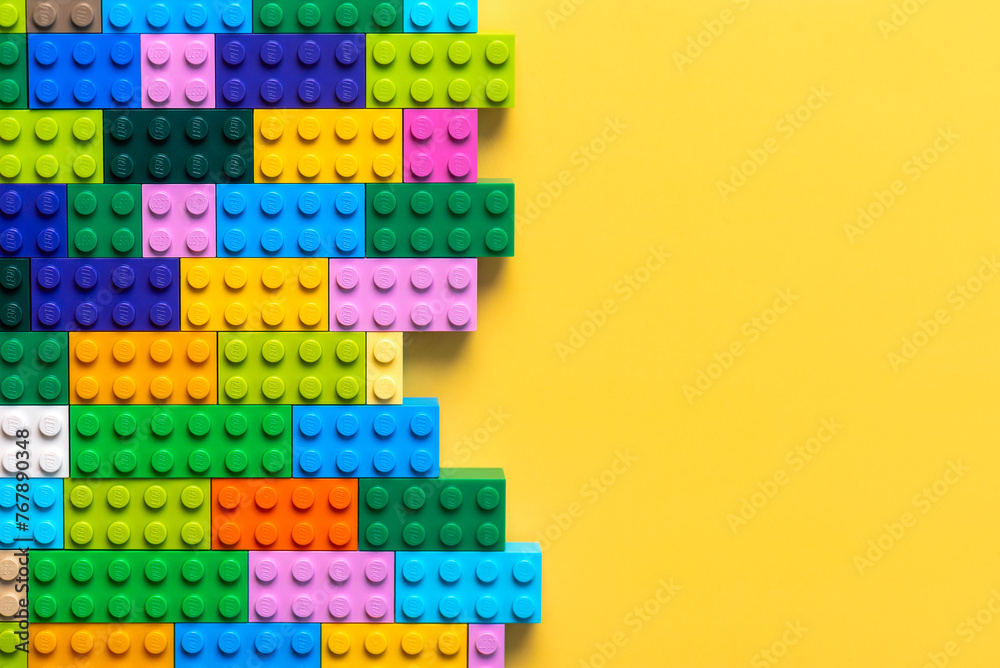 Fototapeta premium Close up of colorful Lego blocks with space for text. Illustrative editorial
