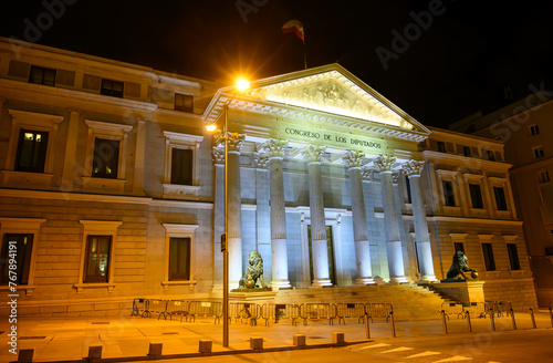 Night view of landmark Palace of Deputies of Spain building in Madrid, Spain, with night illumination.