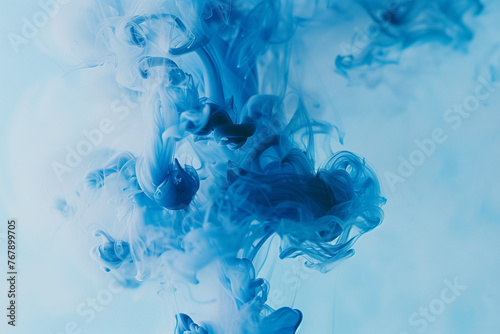 Blue ink in water. Abstract background.