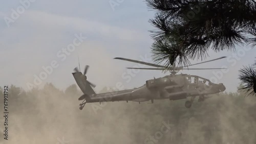 Military Helicopter Flying Low through sand photo