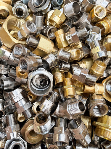 Flat view of mixed brass fittings some with a chrome coating