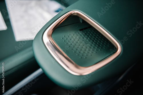 Wireless smartphone charger in the car. Portable wireless car charging for phone battery. Concept of modern technologies. Luxury car inside. Interior of prestige modern electric car.