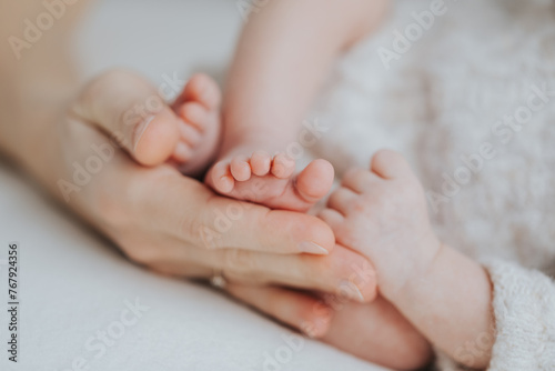 Newborn baby feet in parents hands 