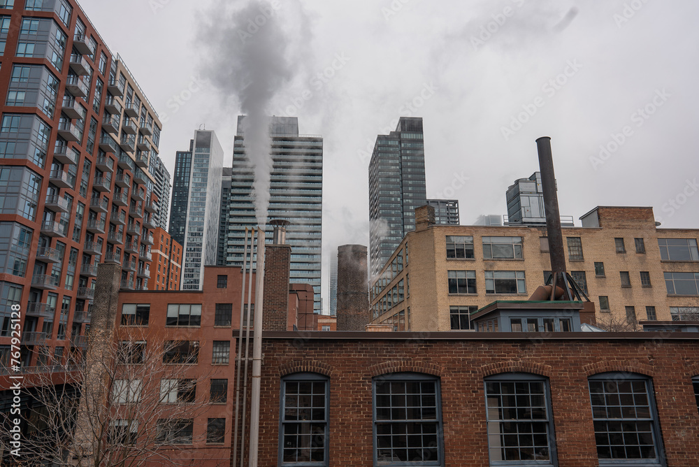 chimney pipe with steam at New York or Toronto, smoke stack on big city with skyscrapers urban background