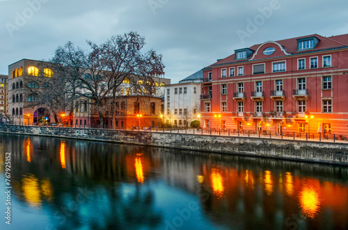 Berlin, Germany, March 9, 2024: various old and new buildings on the northern bank of the river Spree during the blue hour