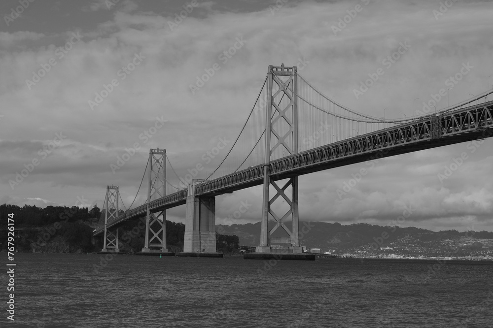 grayscale of a San Francisco bridge stretching across a body of water