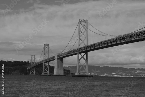 grayscale of a San Francisco bridge stretching across a body of water