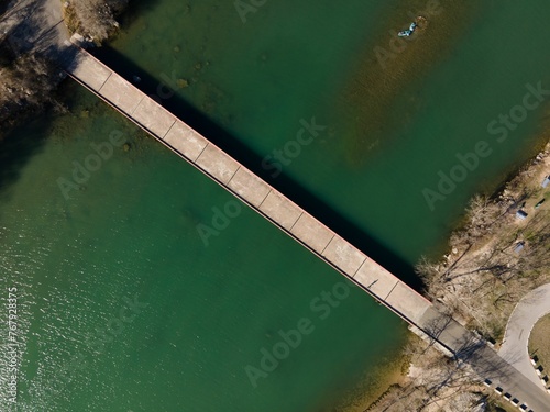 Aerial view of Mansfield Dam with crystal-clear blue water on a sunny day