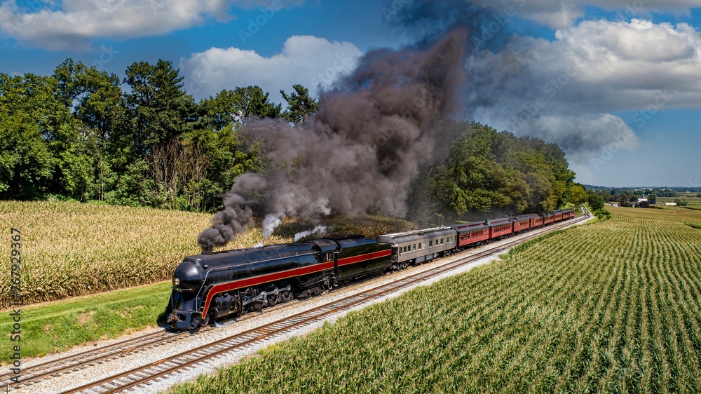 Obraz premium Aerial Front View of a Restored Antique Steam Passenger Train, Traveling Thru the Countryside