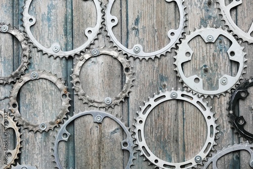 Close-up of several interlocking gears on a light-colored wooden surface