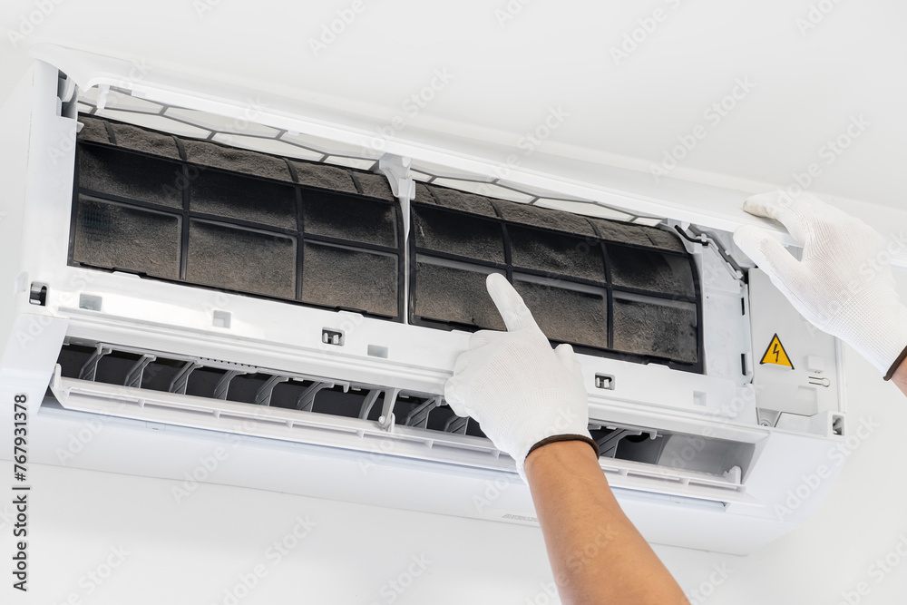 Cleaning the air conditioner by a technician. A lot of dust gets stuck in the air filter. Cleaning the air conditioner by a technician. A lot of dust gets stuck in the air filter.