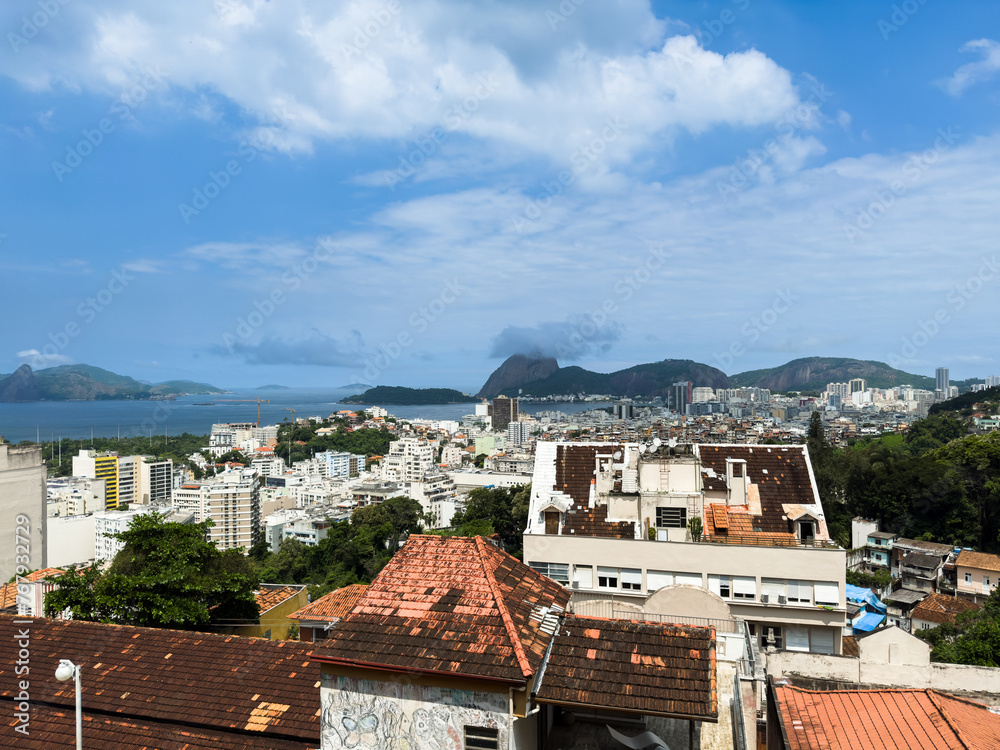 Beautiful view of Sugarloaf Mountain (Morro do Pão de Açúcar), Baia de Guanabara, Niterói, Morro dos Prazeres favela, from a viewpoint in Parque das Ruínas - Rio de Janeiro, Brazil