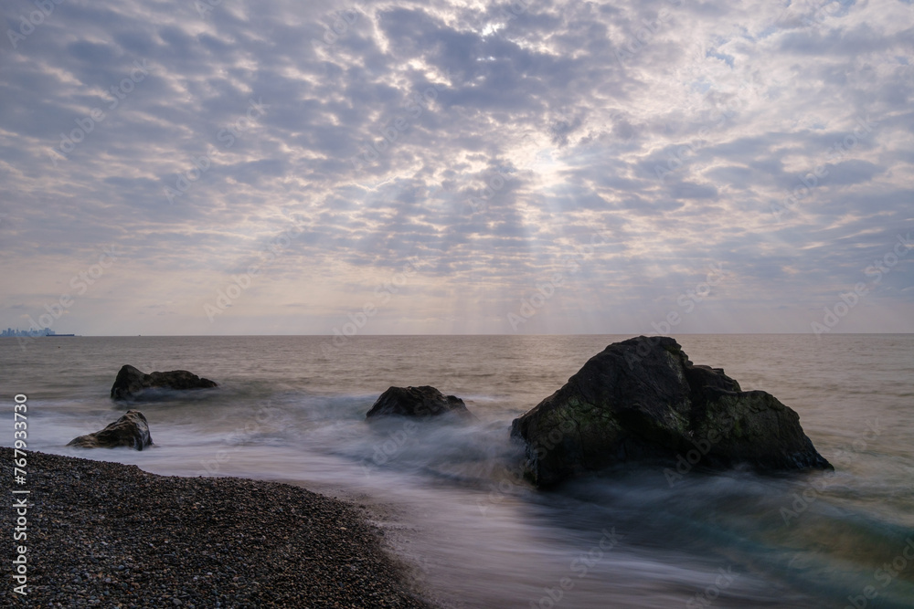Obraz premium Water waves of the Black Sea crashing on rocks on the stony shore, coast - close up, nobody, no people. Nature, element, landscape