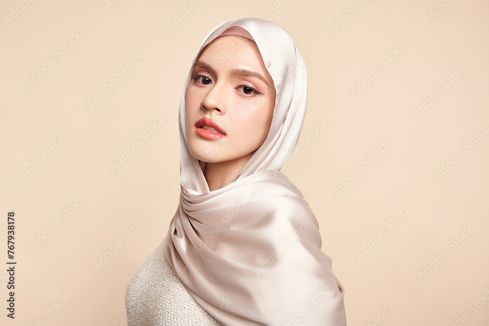 Beautiful young asian muslim woman wearing a white hijab on beige background, Portrait of Arab Beauty. Beautiful young asian muslim woman wearing a white hijab on beige background, Portrait of Arab Beauty.