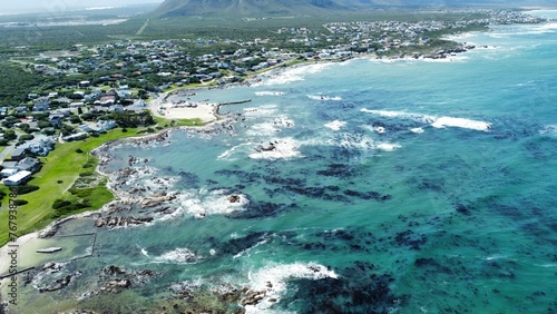 a view from a plane of some buildings by the ocean