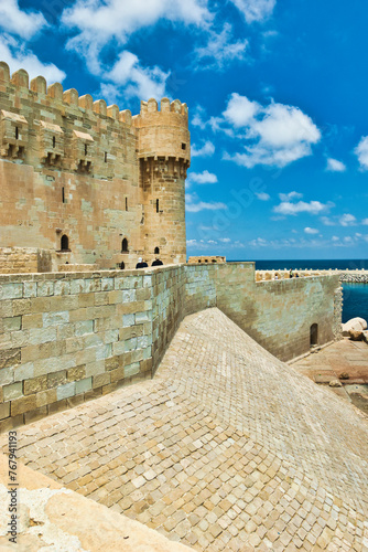 ALEXANDRIA, EGYPT - 14 JUNE 2023 : The Qaitbay Citadel, the famous landmark in Alexandria located by the Mediterranean Sea. This area is believed that it used to be the location of the Pharos.  photo