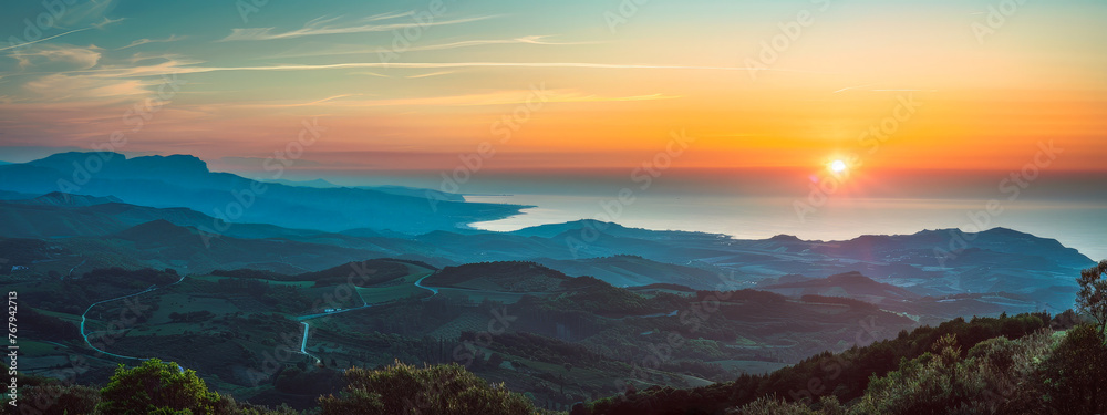 A beautiful sunset over a mountain range with a city in the distance