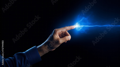 A human finger touching a spark of electrical energy illustrating a concept of power and connection.  Futuristic technology of information transfer