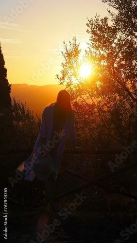 Scenic view of a silhouette of a woman in Tuscany at golden sunset