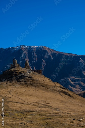 View of an ancient castle situated atop a mountain in Kazbegi, Georgia