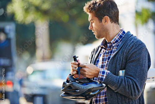 City, man and cyclist outdoors with helmet for eco friendly transportation, adventure and journey on vacation. Male person, mockup and thinking for weekend travel, cycling and tourism in Amsterdam