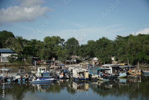 A photo of a dock with many boats © Wirestock