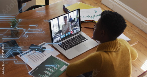 Image of microprocessor connections over african american woman having a image call on laptop
