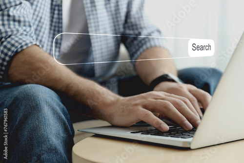 Search bar of website over laptop. Man using computer at table, closeup
