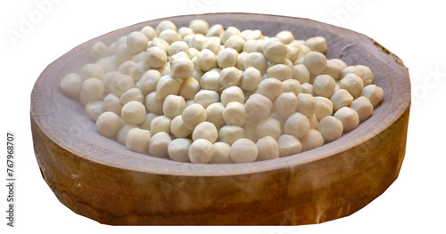 Boiled white fish balls cooked on a wood stove have white smoke indicating the heat..