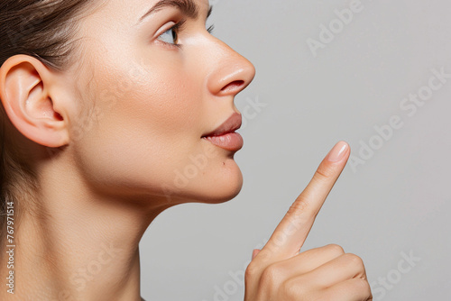 Woman face profile side view. Chin lift pointing with index finger
