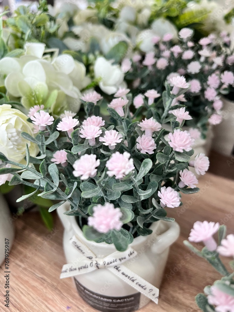 Fototapeta premium artificial Gypsophila flowers in a ceramic pot with a ribbon for interior decoration