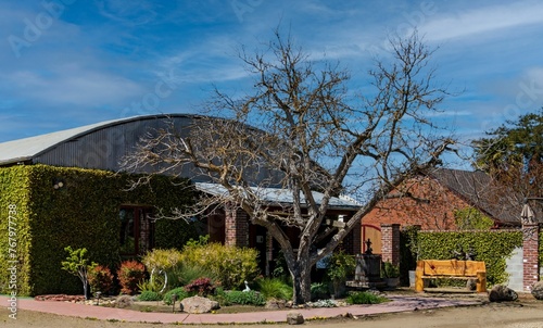 Building situated in a grassy courtyard, surrounded by trees in Lodi California, Winery