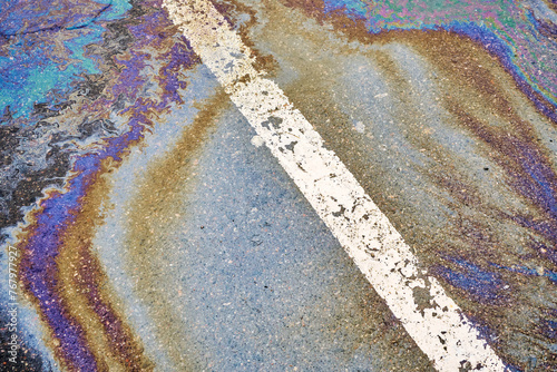 Fototapeta Naklejka Na Ścianę i Meble -  Oil spill on wet asphalt, parking lot with dividing line