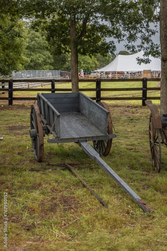 Antique wooden horse-drawn carriage on a grassy field in New England Antique wooden horse-drawn carriage on a grassy field in New England