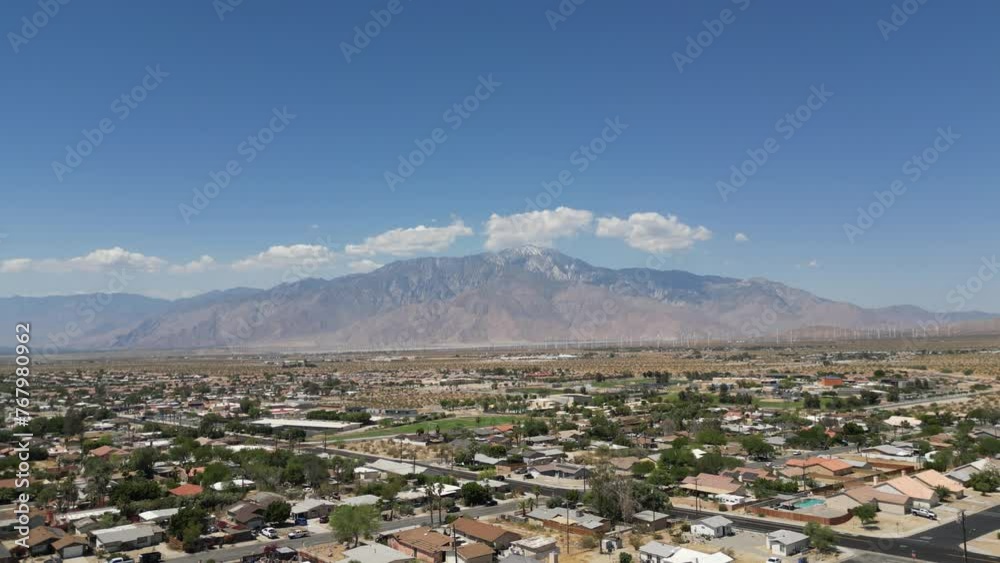 Drone shot over a town with dry landscape on a sunny day Drone shot over a town with dry landscape on a sunny day
