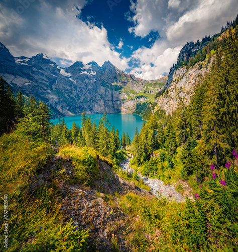 Superb summer view of unique lake - Oeschinen (Oeschinensee), UNESCO World Heritage Site. Nice outdoor scene in Bernese Oberland Alps, Switzerland, Europe. Beauty of nature concept background.. photo