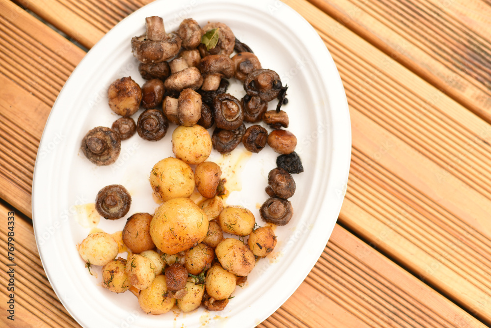 Baked potatoes and mushrooms on a plate Baked potatoes and mushrooms on a plate
