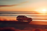 Blurred motion of a modern SUV driving on a concrete road at sunset near the sea. Concept Motion Blur, Modern SUV, Sunset Drive, Concrete Road, Coastal Scenery