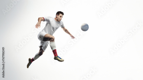 Football Player Strikes Ball Midair on White Background