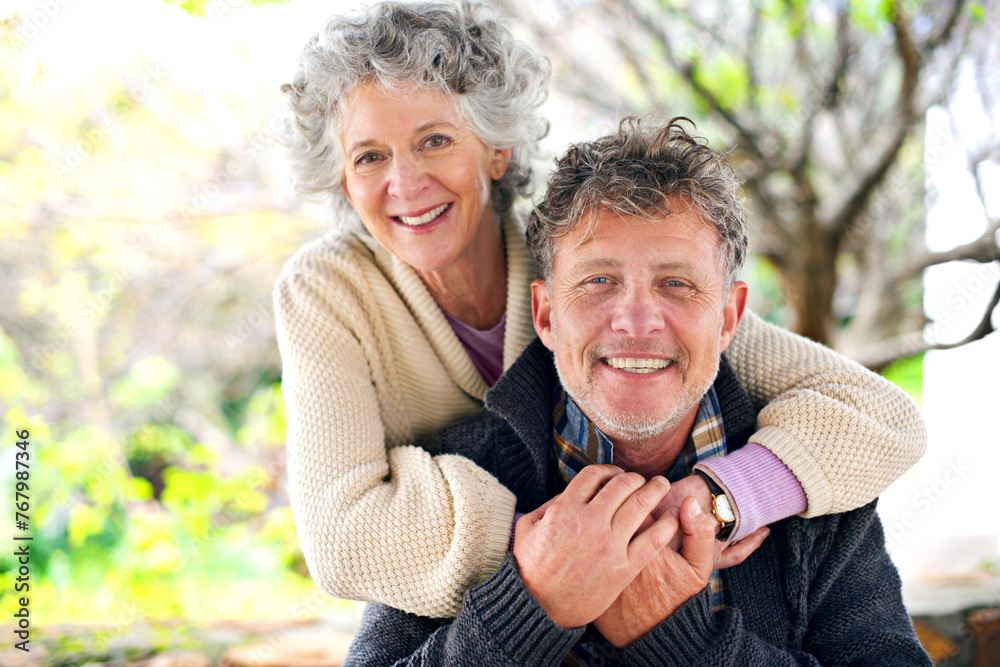 Happy, portrait and senior couple hug outdoor with love on holiday or relax on vacation in retirement. Elderly, man and woman in embrace in backyard or garden of home with care or support in marriage