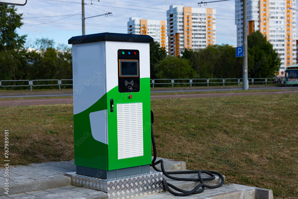 Electric vehicle charging station with power plug for electric vehicles. NFC payment. Smart energy. The concept of ecology and environmental pollution by car emissions. Electric vehicle charging station with power plug for electric vehicles. NFC payment. Smart energy. The concept of ecology and environmental pollution by car emissions.