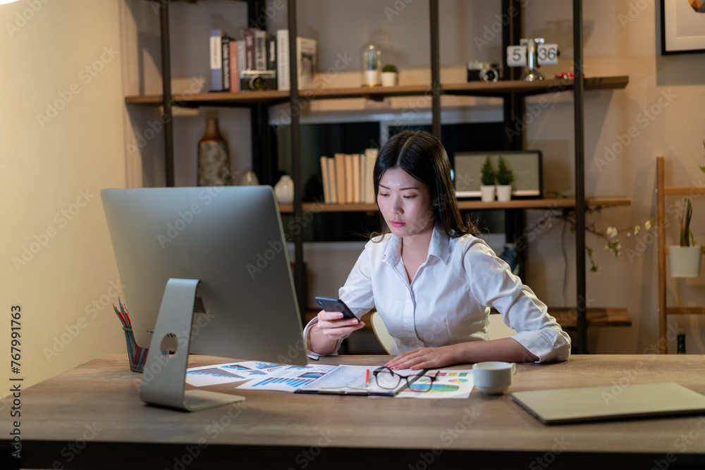 The young woman is working late into the night The young woman is working late into the night