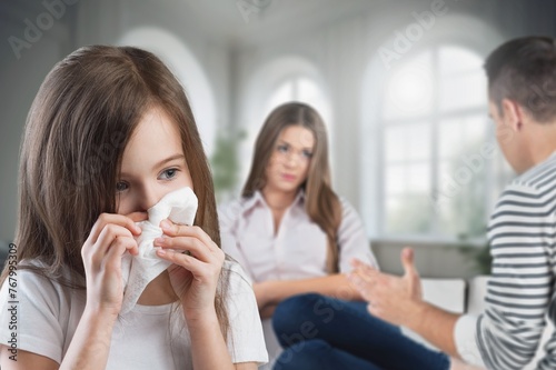 Sad lonely child crying during parents fighting