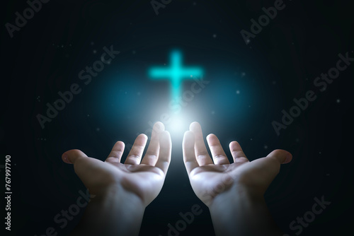 Easter concept, Open hands  holding a glowing cross , symbol of Christian faith. © paul