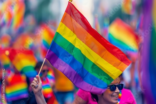 Joyful Person Waving Rainbow Pride Flag at Colorful LGBTQ Community Parade Celebration