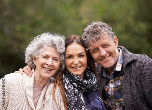 Portrait, outdoor and old parents with daughter, embrace and happiness with nature and bonding together. Face, family or adult with fresh air and hug with smile and senior mother with mature father