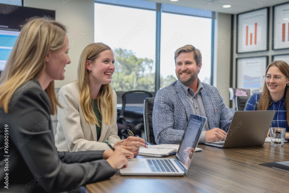Businessmen sit in a meeting and analyze profits with graphs displayed on a screen in the office. Businessmen sit in a meeting and analyze profits with graphs displayed on a screen in the office.