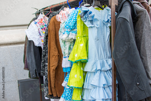 A rack of flamenco dresses hanging up