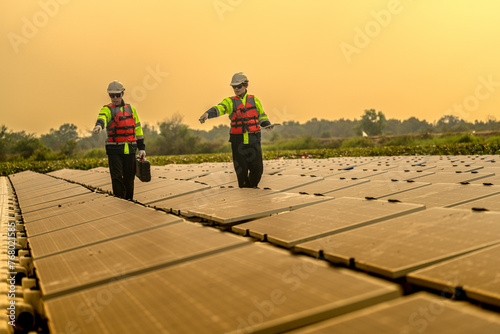 Male workers repair Floating solar panels on water lake. Engineers construct on site Floating solar panels at sun light. clean energy for future living. Industrial Renewable energy of green power.