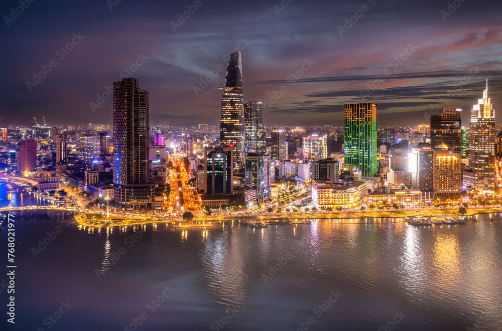 Aerial panoramic cityscape view of HoChiMinh city and the River Saigon, Vietnam with blue sky at sunset. View from Thu Thiem peninsula